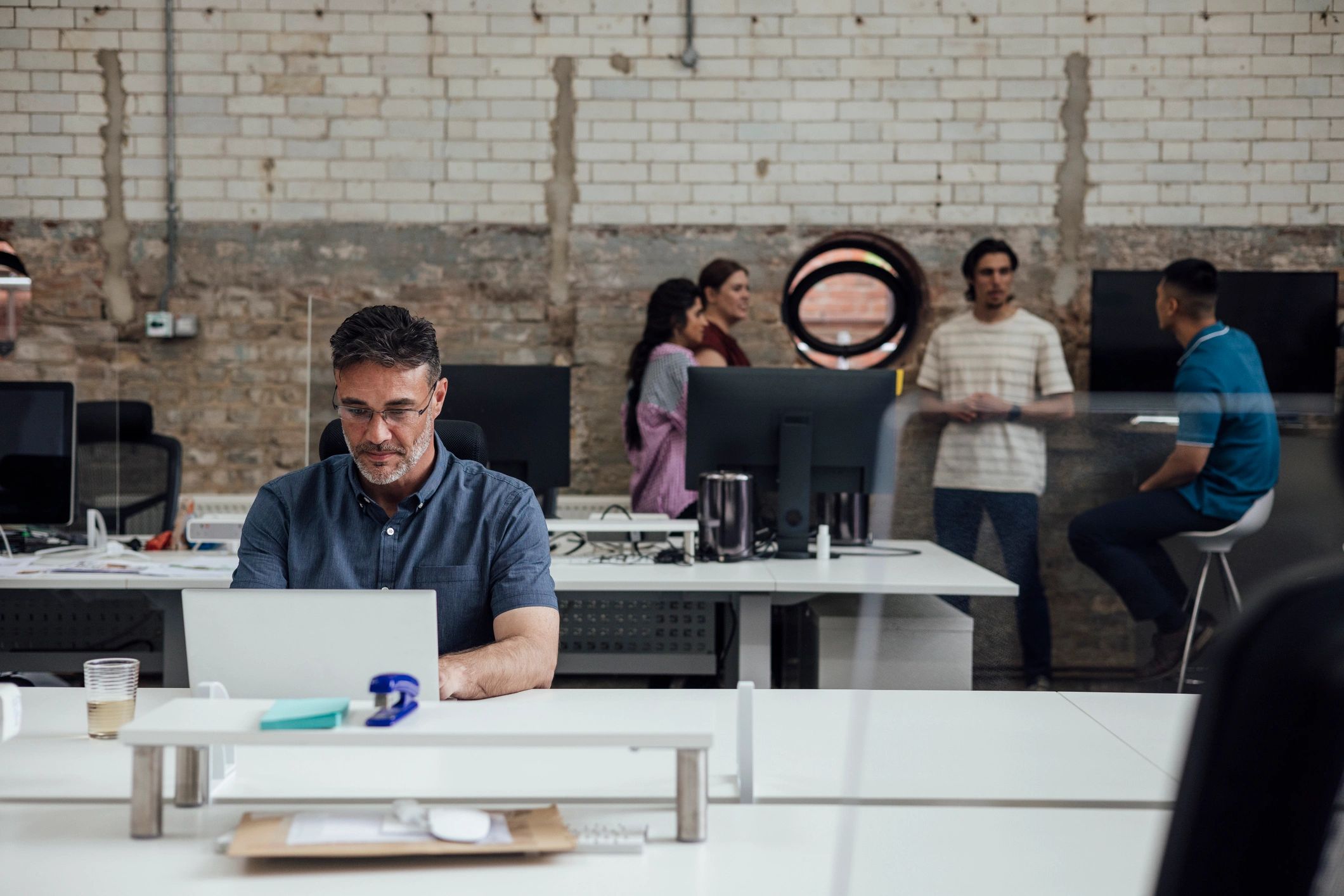Business professional working at a laptop in a modern office