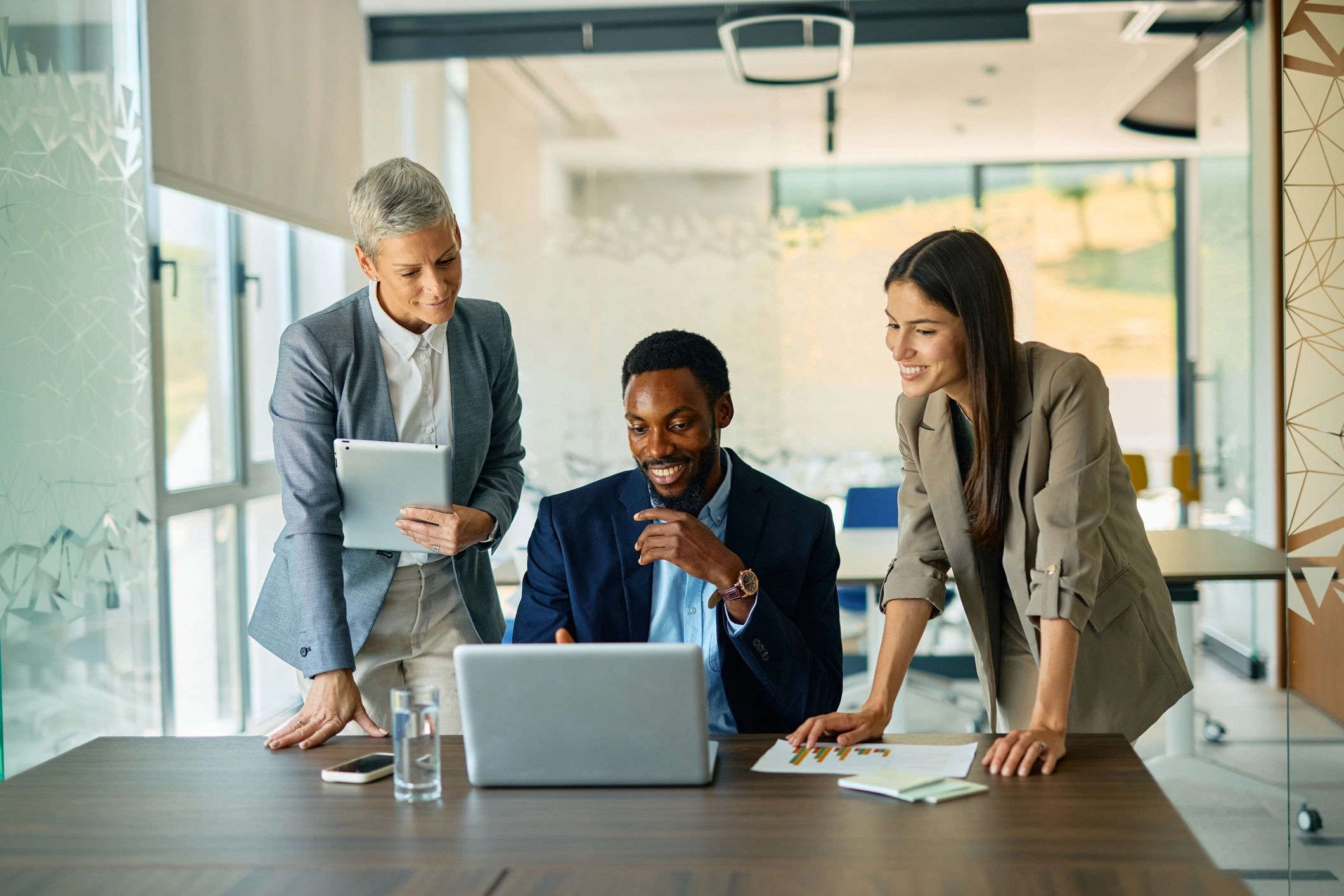 Business professionals collaborating with technology in an office