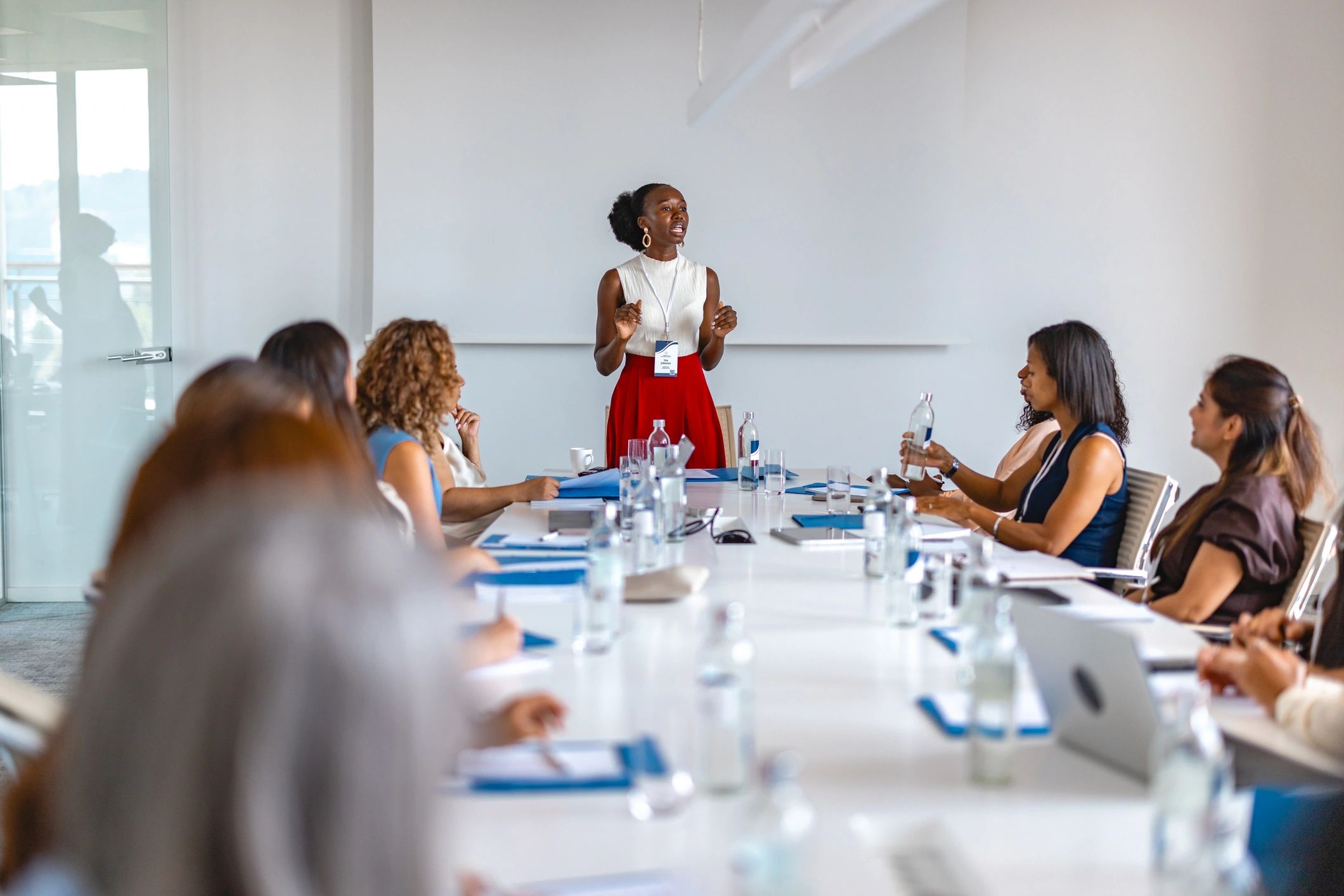 Business professional presenting to a team in a conference room